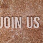Wooden letters spelling 'Join Us' on a brown textured surface, suitable for invitations.