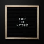 A chalkboard with the motivational message 'Your Life Matters' in white letters.