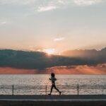 Silhouette of person jogging by the sea during a picturesque sunset in İstanbul, Turkey.
